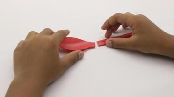 a child's hands are holding two red plastic spoons-4 photo