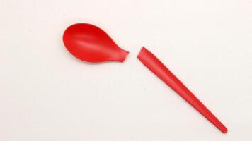Broken red plastic spoon isolated-4 photo