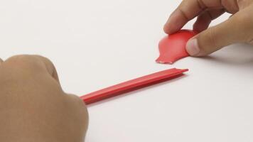 a child's hands are holding two red plastic spoons-9 photo