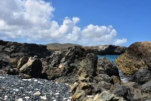 Rugged Rocks Surrounding a Cove in Aruba photo