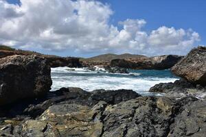Black Sand Beach in Aruba with Crashing Waves photo