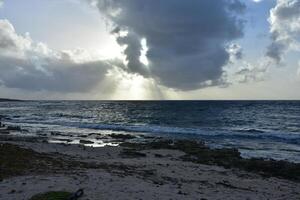 Amazing Rays of Sun Shining Through Clouds on Ocean photo