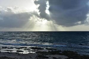 Rays of Sunshine Shining out of Clouds at Bachelors Beach photo