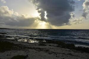Golden Rays of Sun Through the Clouds in Aruba photo
