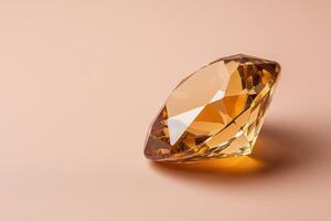 Close up of a sparkling golden diamond on a peach background photo