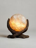 Illuminated onyx sphere table lamp on a wooden base photo