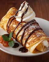 Delicious crepe with whipped cream and chocolate sauce photo