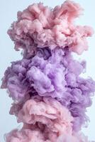 Abstract pink and purple ink swirling in water, creating a vibrant and colorful cloud of smoke photo