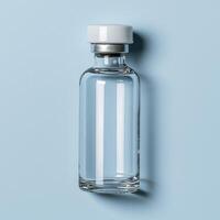 Glass vial with a white cap on a blue background photo