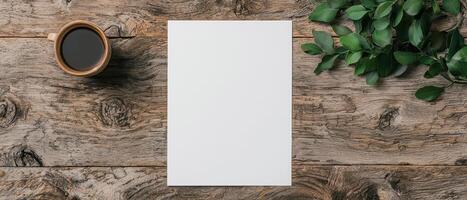 Blank paper mockup on rustic wooden table with coffee and green leaves photo
