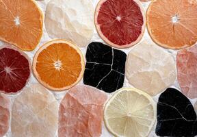 Citrus fruit slices arranged on a stone background photo