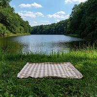 Picnic blanket by a lake in a forest photo