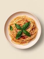 spaghetti with tomato sauce and basil leaves on a plate photo