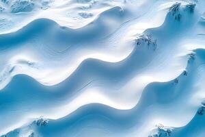 Aerial View of Pristine Snow-Covered Landscape with Curved Patterns for Winter Design photo