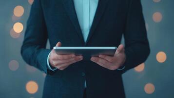 man in suit holding tablet with blurred background of lights, conveying professionalism and modern technology photo