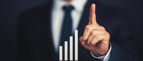 Financial advisor pointing at bar chart showing growth and success photo