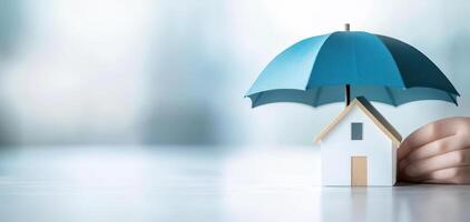 small house model is protected by blue umbrella, symbolizing safety and security photo