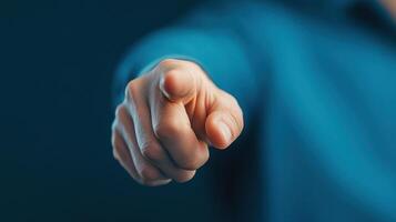 hand pointing forward, conveying sense of direction and authority. blue background adds professional touch photo