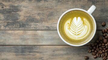 Matcha latte art in white ceramic cup on rustic wooden table, surrounded by coffee beans, creating cozy atmosphere photo