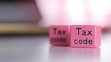 Tax code blocks in pink color on white surface, symbolizing tax regulations photo