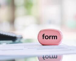 Neatly arranged tax form documents with pink stamp labeled form evoke sense of organization and professionalism photo