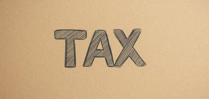 Hand drawn TAX lettering on kraft paper background, conveying sense of simplicity and clarity photo