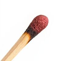 close up macro shot of matchstick head, showcasing its detailed texture and burnt tip photo