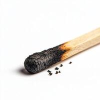 detailed macro shot of burnt matchstick with charred tip and ash photo