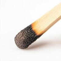 close up of matchstick with detailed burn mark, showcasing texture and color photo