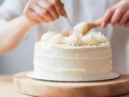 Smoothly spreading icing on cake with hands and spatula, creating beautiful dessert photo