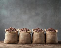 Woven sacks filled with cocoa beans arranged on textured surface photo