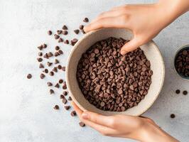 Adding chocolate chips to mixing bowl creates delightful baking experience photo