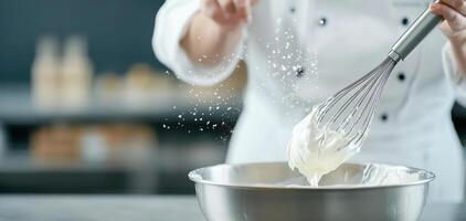 Whisking cream stainless steel bowl, chef creates fluffy texture. kitchen atmosphere is filled with excitement and creativity photo