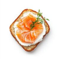 Toasted bread topped with cream cheese and smoked salmon, garnished with dill photo