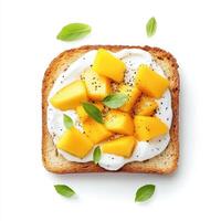 Toasted bread topped with mango slices, cream, and fresh herbs creates delightful breakfast photo