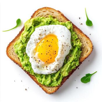Toasted bread topped with mashed avocado and poached egg, garnished with pepper photo