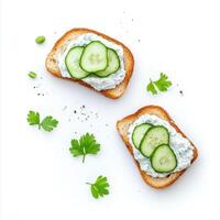 Toasted bread with tzatziki and cucumber slices garnished with herbs photo