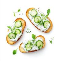 Toasted bread topped with tzatziki and fresh cucumber slices, garnished with herbs. refreshing and healthy snack option photo