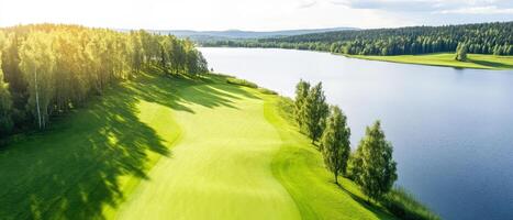bright and colorful golf course bordered by serene water and lush trees photo