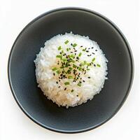 Fluffy cooked rice topped with black sesame seeds and chives in bowl photo