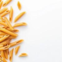 Penne pasta arranged on white background, showcasing its unique shape and texture photo
