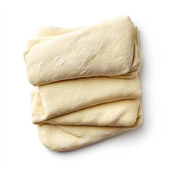 Fresh dough sheets stacked neatly, showcasing smooth texture and soft appearance, perfect for baking photo