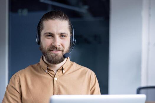 A friendly customer service representative wearing a headset and smiling while working remotely from their office using modern technology for communication and assistance. photo