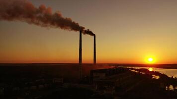 Smokestack in factory with yellow cloudless sky. Sunset above modern factory. Panoramic with drone. video