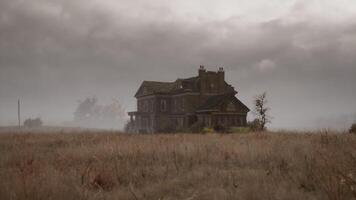 Dark clouds loom over an abandoned house in a desolate landscape video