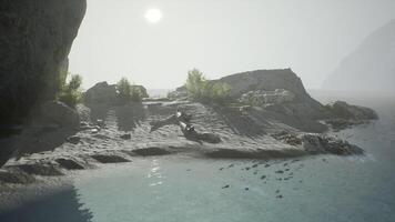Serene coastal landscape in Indonesia during a hazy sunrise over calm waters video