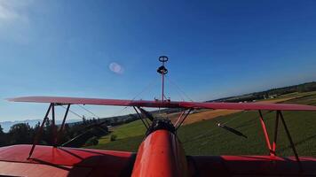 Red Biplane Landing Captured from Tail View on Clear Day video