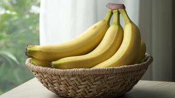 Ripe yellow bananas in a wicker basket on a table near a window. photo