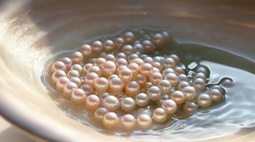 Close-up of lustrous pearls in a shallow bowl of water. photo