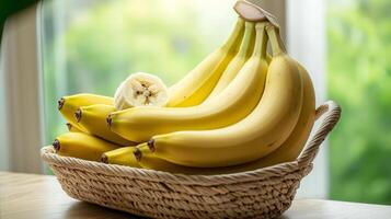 Ripe yellow bananas in a wicker basket on a wooden table. photo
